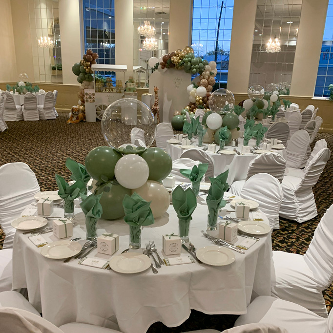 Banquet hall room decorated with green and white baloons