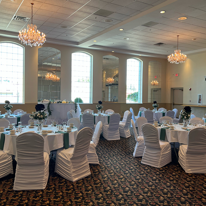 Banquet hall room with chandeliers and white linens