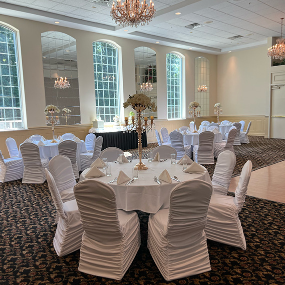 The Queen Room banquet hall decorated with white and neutral linens
