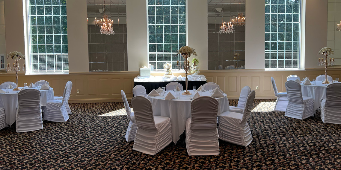 The Queen Room banquet hall decorated with white and neutral linens