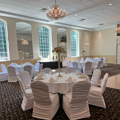 White and neutral linens on tables in a banquet hall