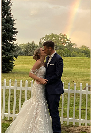 Couple on the patio in front of a rainbow